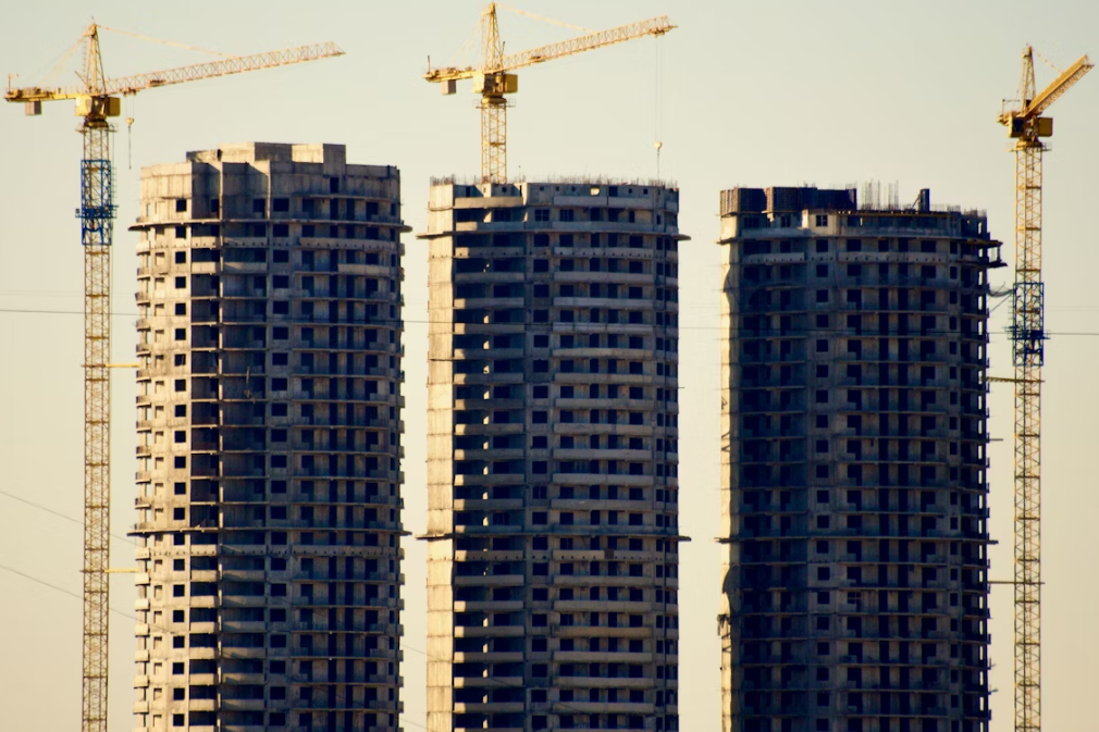 Modern real estate construction site with cranes and buildings